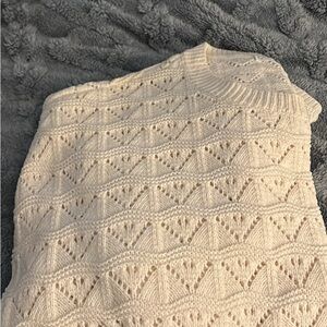 An off white sweater size large. Never been worn.